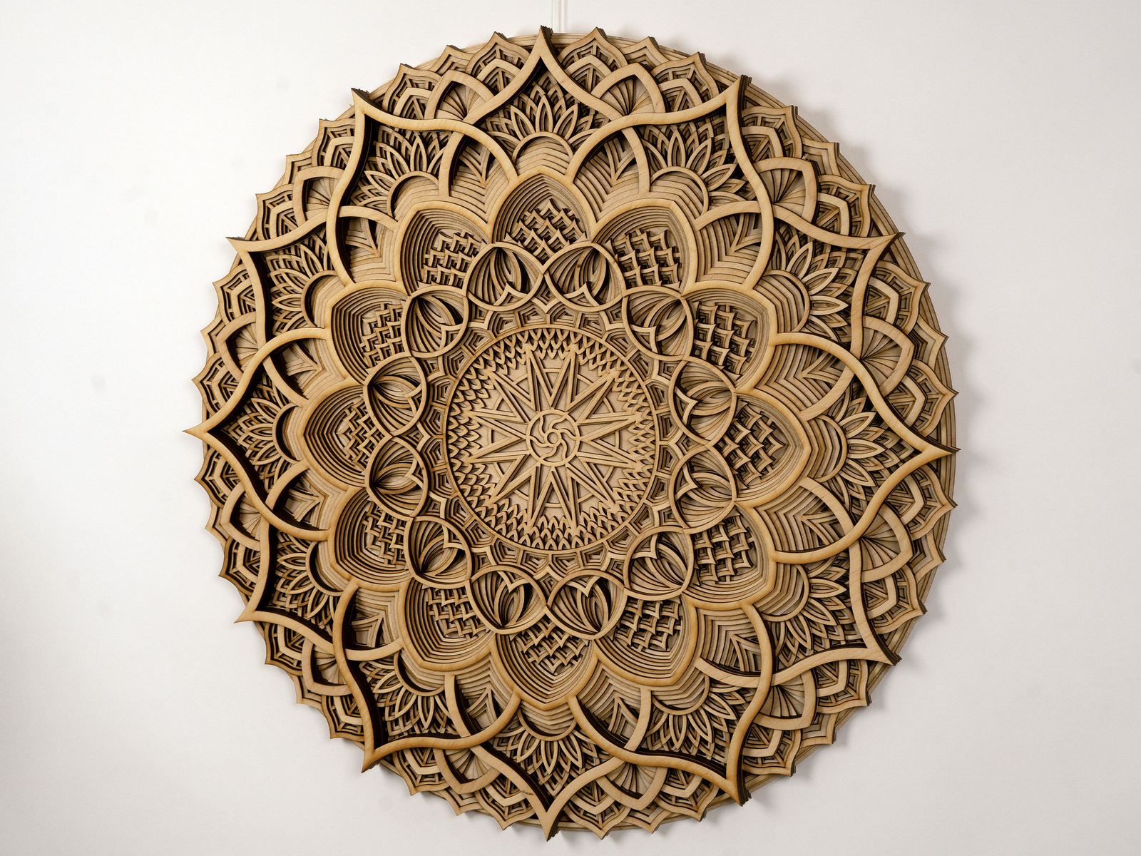 A round, wall-mounted wooden mandala art piece with intricate geometric patterns.