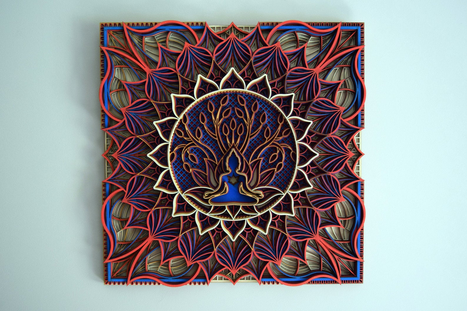 A colorful wooden mandala wall art with intricate geometric patterns and a central tree of life design, laser-cut and assembled.